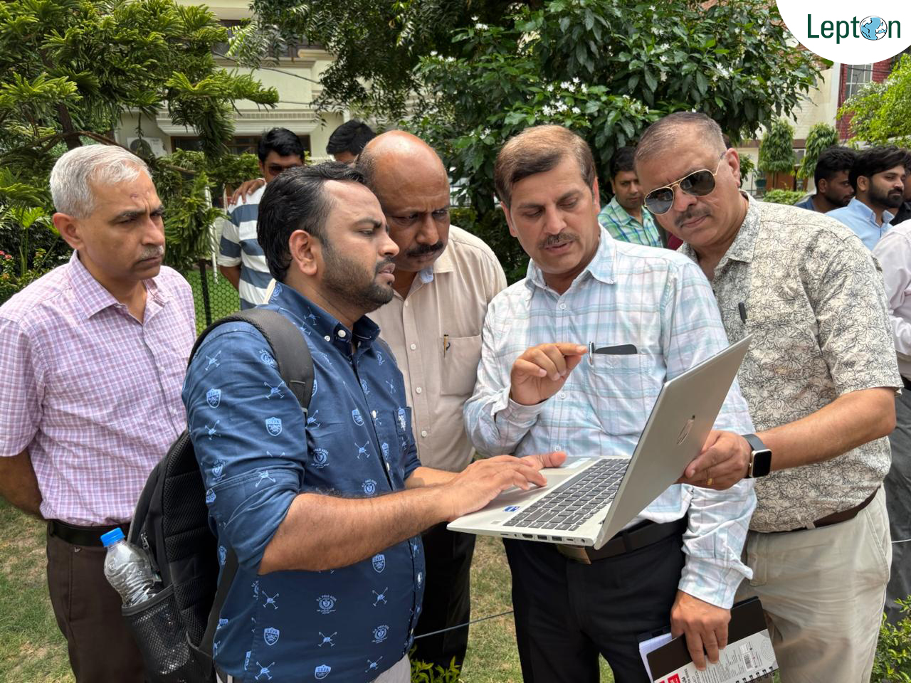 Lepton field team reviewing a BharatNet feasibility survey on a laptop on site