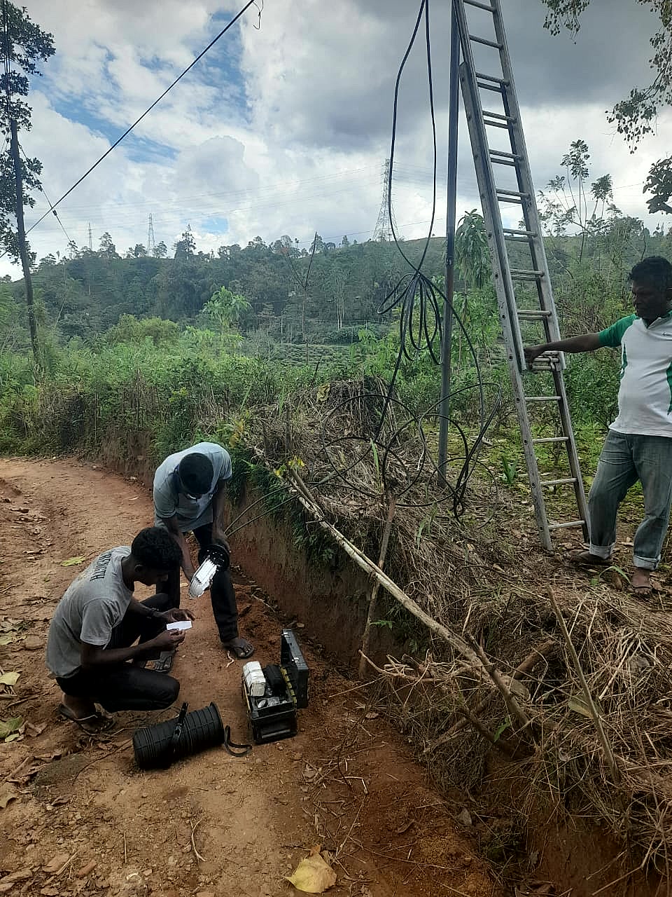 Dialog Axiata field team restoring a fibre span at a damaged utility pole in Sri Lanka