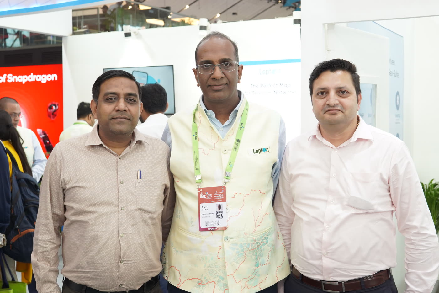 Lepton Software team at the IMC 2025 booth in front of the NetworkAccess product wall